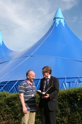 The Bishop helps Church of Ireland Gazette assistant editor the Rev Clifford Skillen, rector of St Polycarp's, find his way around the campus. The Big Top is in the background.